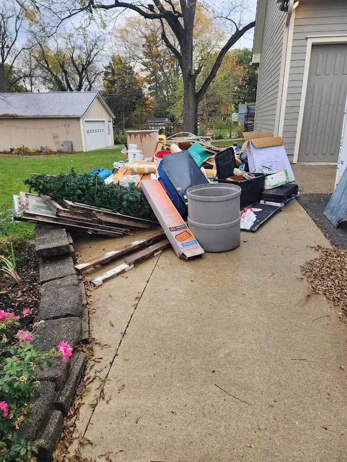Dumpster being loaded with debris for Roofing Dumpster Rental in Norton Shores